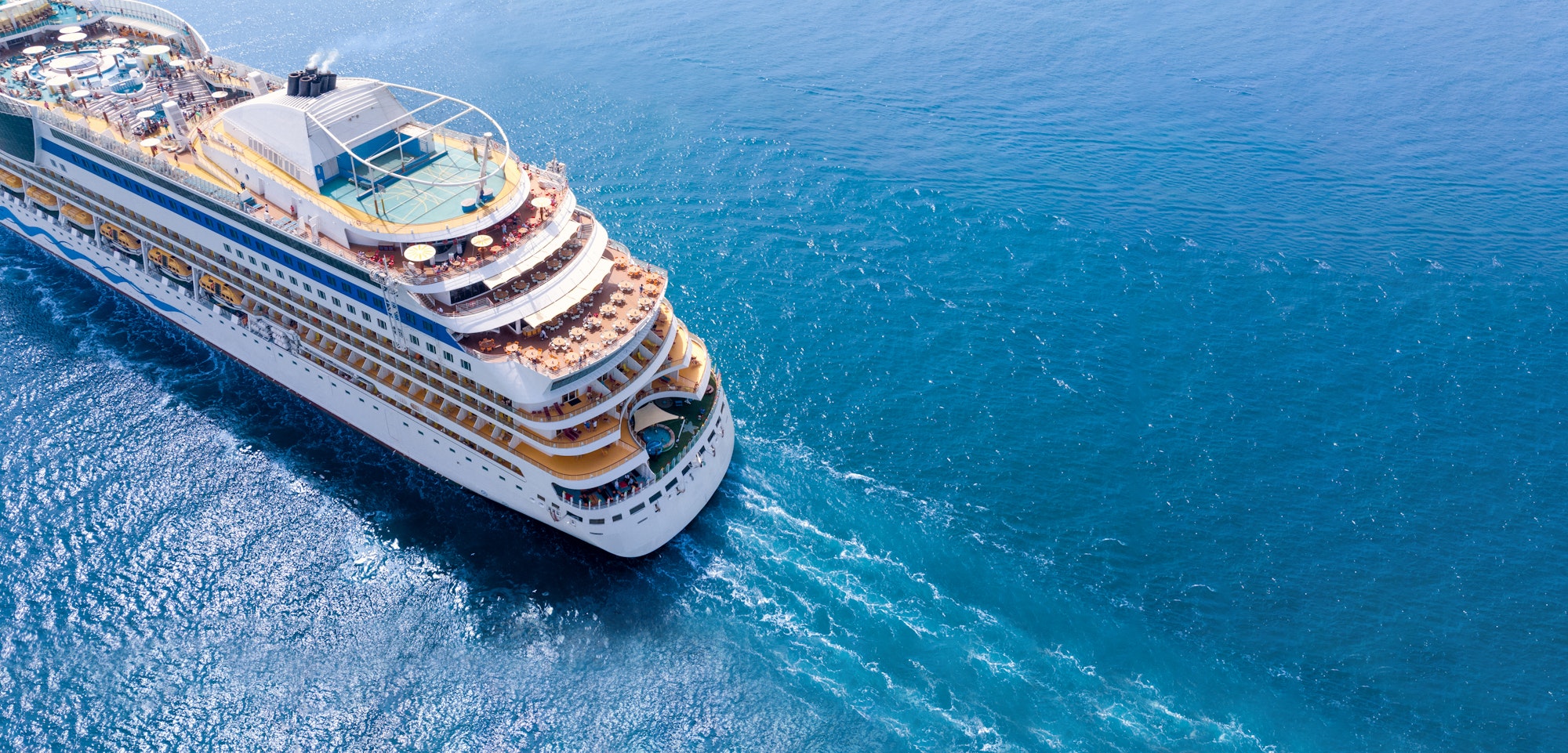 Aerial view of beautiful white cruise ship above luxury cruise close up at stern of cruise