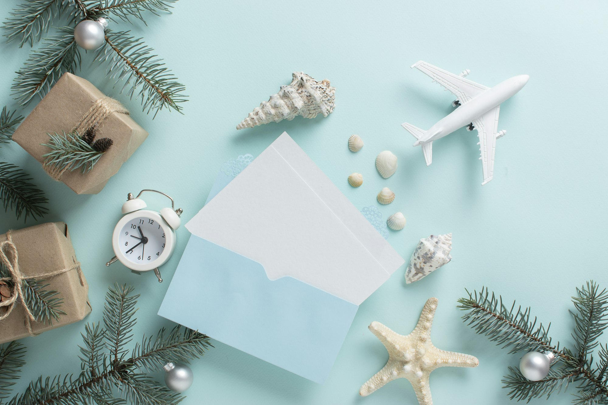 cards, an airplane, and fir branches with Christmas decorations and gifts in eco-packaging.